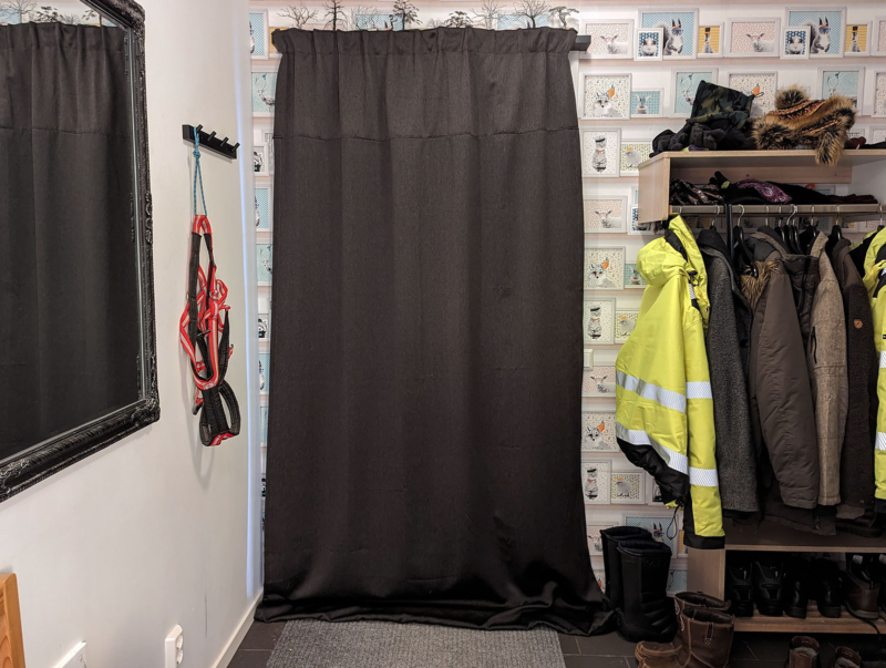 A hallway with a heavy curtain covering the door